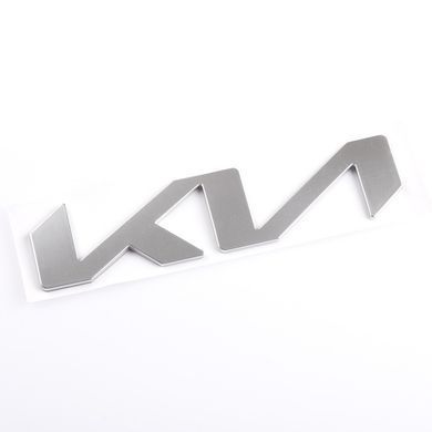 Купить Эмблема надпись Kia NEW СЕРАЯ 130х30 мм металл на скотче (Завод) 88583 Эмблема надпись на иномарки